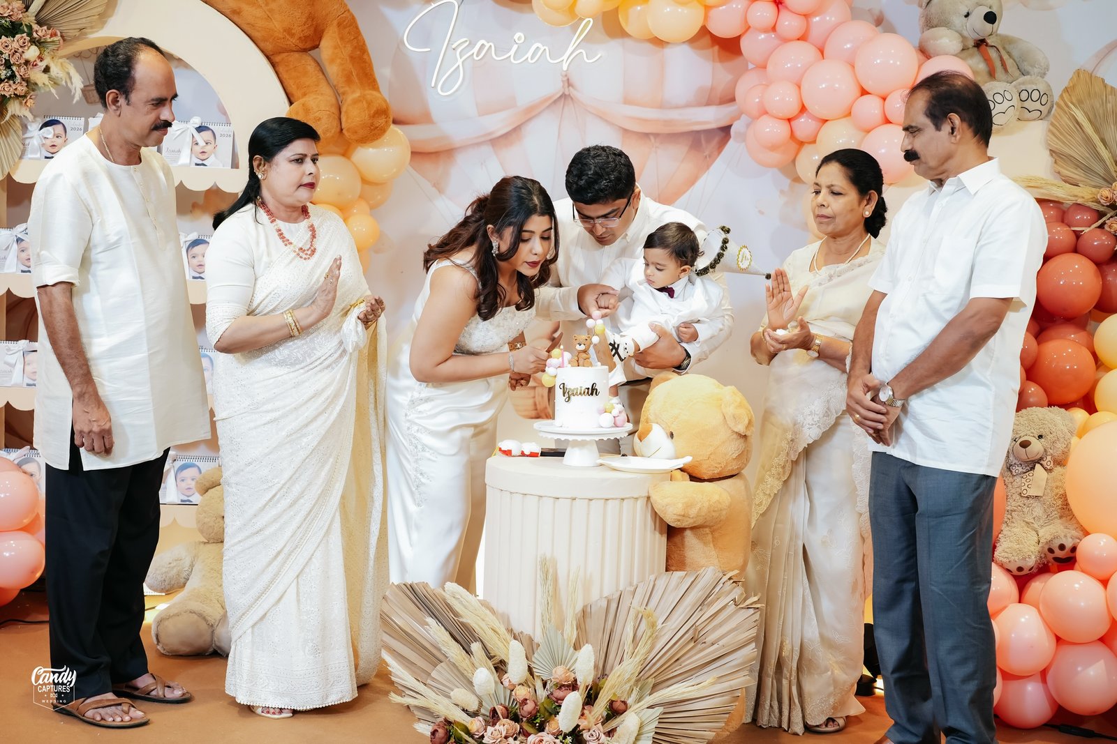 A baby's first birthday cake celebration with family
